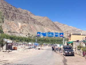 Clearing a passport check in Upshi, looking back north towards Leh, posted "49km"