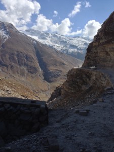 1 of a series of 4. A person walks around the corner of the dusty and narrow stretch of Leh-Manali Hwy between Tandi and Gramphoo (post the Glacier).