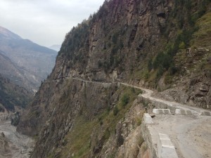 A view forward on way to rejoin the highway 22 at the hydro power station after a short stay in Chitkul. Given more time, perhaps a nice place to organize a trek for the surrounding passes, valleys and forests. Here, where the road juts over the valley for the second in the middle of photograph, you can barely make out a white leaning sign on the left of the roadway; it reads "Drive Slow", and has been hit.
